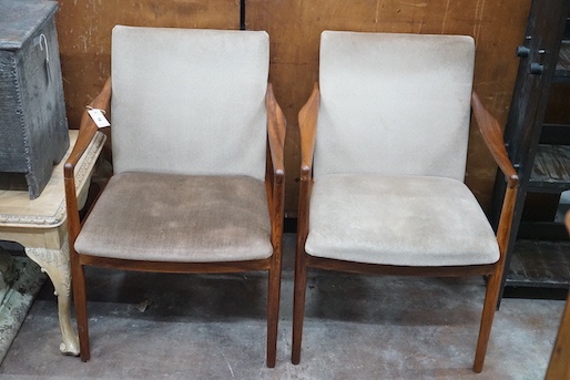 A pair of mid century teak upholstered elbow chairs, width 54cm, depth 63cm, height 84cm